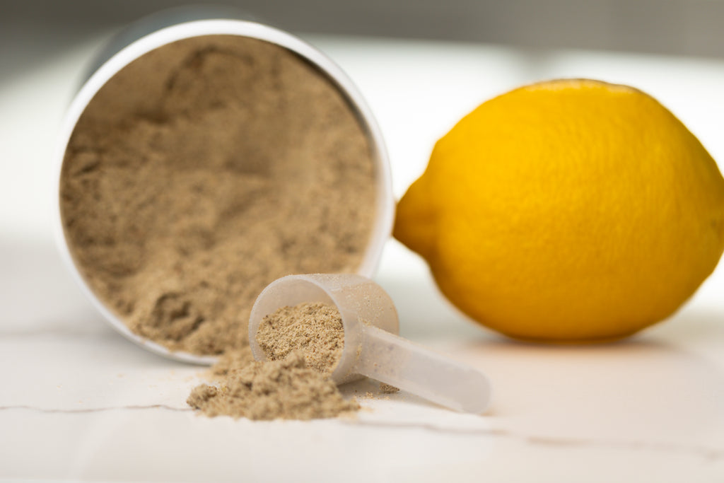 Oxalate Relief powder in an earlier jar, with a scoop and a lemon